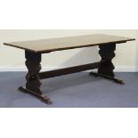 A 20th Century oak refectory table, the rectangular top raised on shaped supports united by a