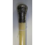 A late 19th Century ivory short cane/swagger stick, the tapering shaft with a foliate engraved white