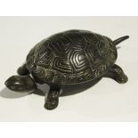 An early 20th Century cast iron clockwork novelty desk-top bell in the form of a tortoise, the