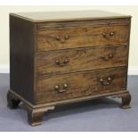 A George III mahogany chest of three long drawers fitted with a brushing slide, on ogee bracket