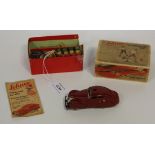 A Schuco 3000 telesteering car, finished in burgundy, length approx 10.5cm, with steering wheel,