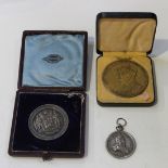 A silver fob medallion, detailed 'Philip V Hispan', 1710, with a crown and ring suspension, a silver