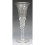 An oversized wine glass, 19th Century, the drawn trumpet bowl on a facet cut stem and folded foot,