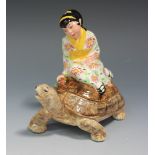 A Goldscheider Staffordshire Pottery Ltd box and cover, modelled as an Oriental girl seated on the