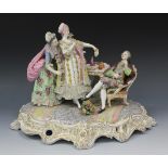 A Continental porcelain figure group, late 19th/early 20th Century, modelled as a gentleman seated