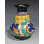 A Gouda pottery vase, the stepped tapering body decorated with flowers, painted and impressed