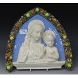 An Italian maiolica wall plaque, late 20th Century, of arched form, decorated in relief with half-