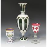 A Bohemian white flash overlay green glass vase, late 19th Century, of baluster form, cut with