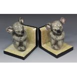 A pair of Goldscheider Staffordshire Pottery Ltd bookends, 1946-1959, each modelled as a seated