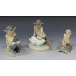 Three Royal Copenhagen porcelain figures, comprising a faun playing with a white rabbit, on a