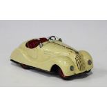 A Schuco Examico 4001 two seat open top sports car, finished in cream, length approx 14.5cm (