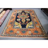 A Turkish carpet, late 20th Century, the blue field with a bold medallion and palmettes, within a