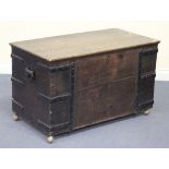 A late 19th Century oak and metal bound trunk, the hinged lid revealing two drawers, the sides
