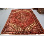 A North-west Persian carpet, mid/late 20th Century, the pink field with an angular medallion and