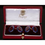 A pair of Asprey silver and enamelled cufflinks, each oval back and front enamelled in red within