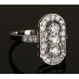 A diamond ring in a curved panel shaped design, mounted with the three principal circular cut