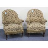 A pair of 19th Century tub back scroll armchairs, upholstered in floral fabric, raised on turned and