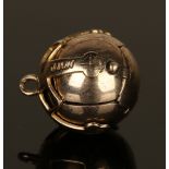 A gold and silver gilt Masonic pendant of spherical form, opening to reveal engraved Masonic