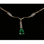 An 18ct gold, emerald and diamond necklace, the front claw set with the pear shaped emerald with a