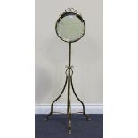 A late 19th Century brass adjustable shaving mirror, on scrolling supports, height approx 119cm.