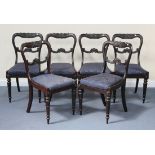 A set of six early Victorian rosewood spoon back dining chairs, the carved rails above drop in