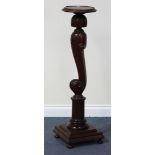 A 19th Century mahogany carved torchère, the circular brass beaded top raised on a scroll support,