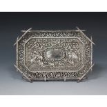 An Indian white metal dressing table tray of rectangular form with canted corners, decorated in