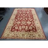 An Afghan 'Ziegler' style carpet, modern, the red field with overall flowering vines and