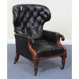 An early 19th Century black leather wing back armchair, the reclining button back above scroll arms,