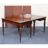 A 19th Century mahogany dining table, the top with four extra leaves, raised on turned legs with