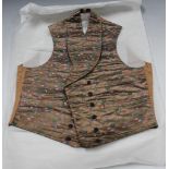 An early 19th Century woven silk gentleman's waistcoat, decorated with a repeating floral spray