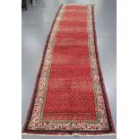 An Arak runner, North-west Persia, the red field with overall offset rows of boteh, within an