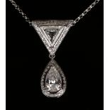 A diamond pendant, the top mounted with a triangular cut diamond in a surround of small circular