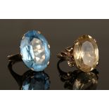 A gold ring, claw set with an oval cut citrine between floral decorated shoulders, detailed '9ct',