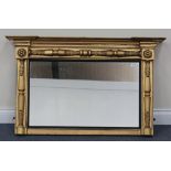 A 19th Century gilt overmantel mirror, the inverted breakfront pediment above an acanthus leaf and