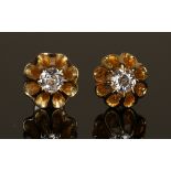 A pair of gold and diamond single stone earstuds, each mounted with a circular cut diamond, the