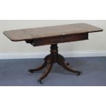 A Regency mahogany sofa table, fitted with two frieze drawers, raised on a turned column support and