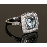 A white gold, aquamarine and diamond ring, mounted with the square cut aquamarine in a surround of