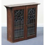 An Edwardian oak hanging bookcase, fitted with leaded and stained glass doors, height approx 88cm,