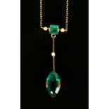 A gold, seed pearl and green gem set pendant necklace, the front with a lozenge shaped green gem set