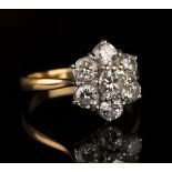 A gold and diamond seven stone cluster ring, claw set with the principal circular cut diamond in a