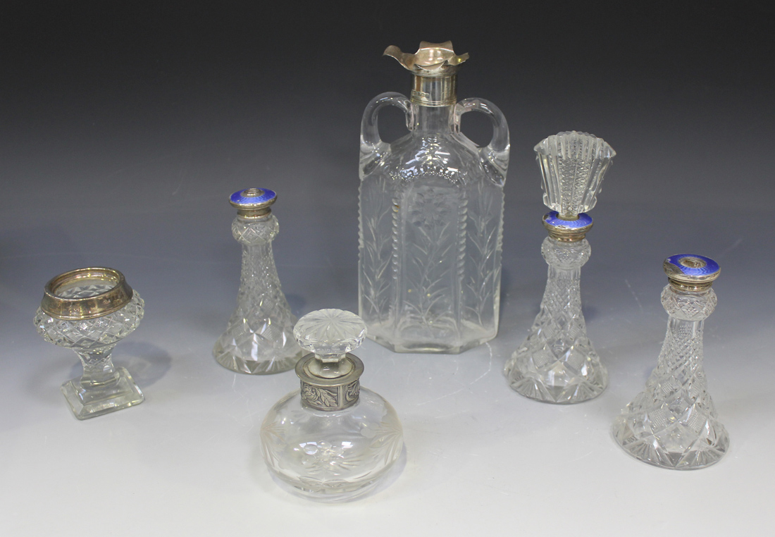 An Edwardian silver mounted cut glass decanter of hexagonal flask form with two handles, each side