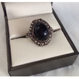 Silver marcasite dress ring with central oval onyx cabouchon. Size M.
