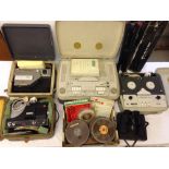 A quantity of c1960s cine projectors and reel to reel machines with a cased pair of binoculars and a