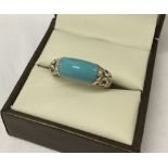 Silver dress ring with turquoise set in an ornate mount. Size O.