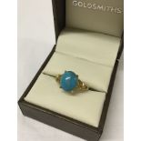 Ladies turquoise dress ring set in 9ct gold. Size R.