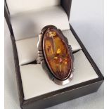 Ladies large silver ring set with faux amber. Size T.