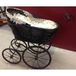 Vintage ornate dolls pram, ideal for doll display. Edged with lace.