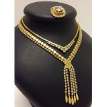 2 goldtone and diamante necklaces together with a matching brooch.