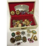 Cream jewellery box containing a good quantity of vintage brooches.